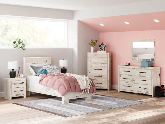 Modern white distressed bedroom furniture set with pink bedding, nightstands, dresser, and mirror in cozy teen girl room