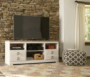 Modern white TV stand with storage drawers and shelves, styled in cozy living room with stone wall