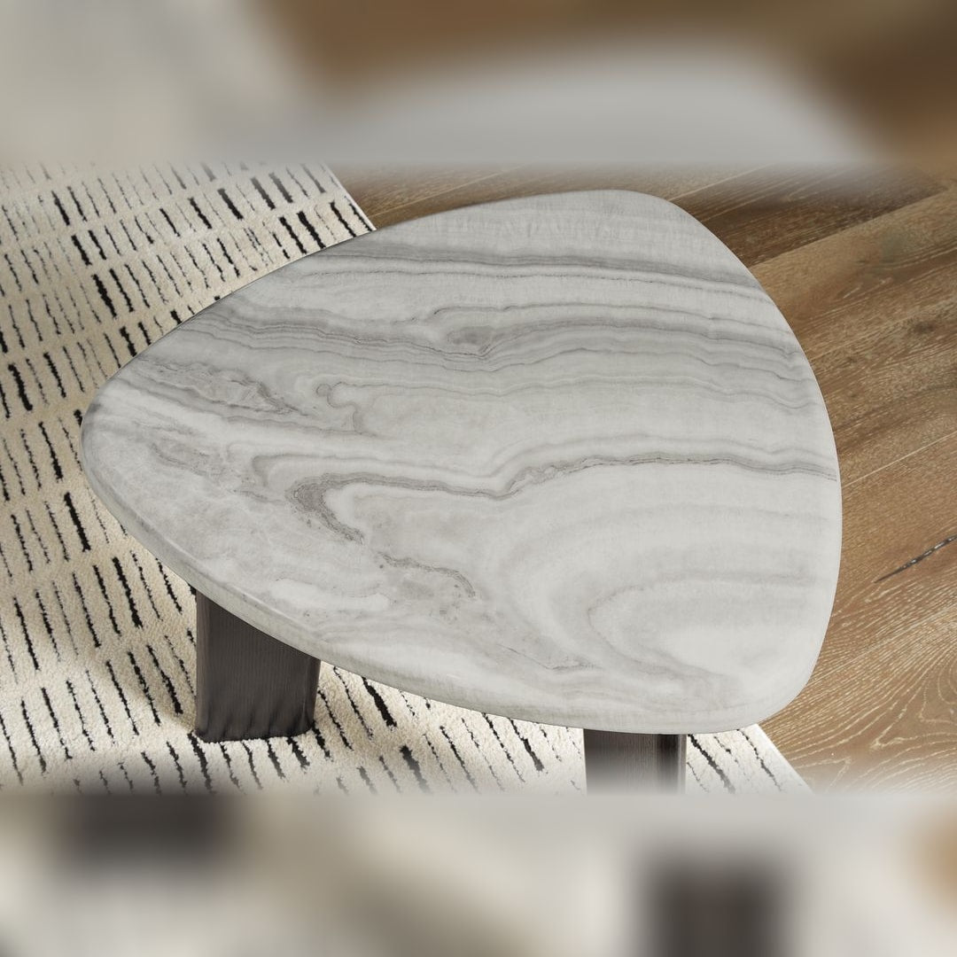 Close-up of a Lilyberg end table's black tapered leg meeting the marble-look top