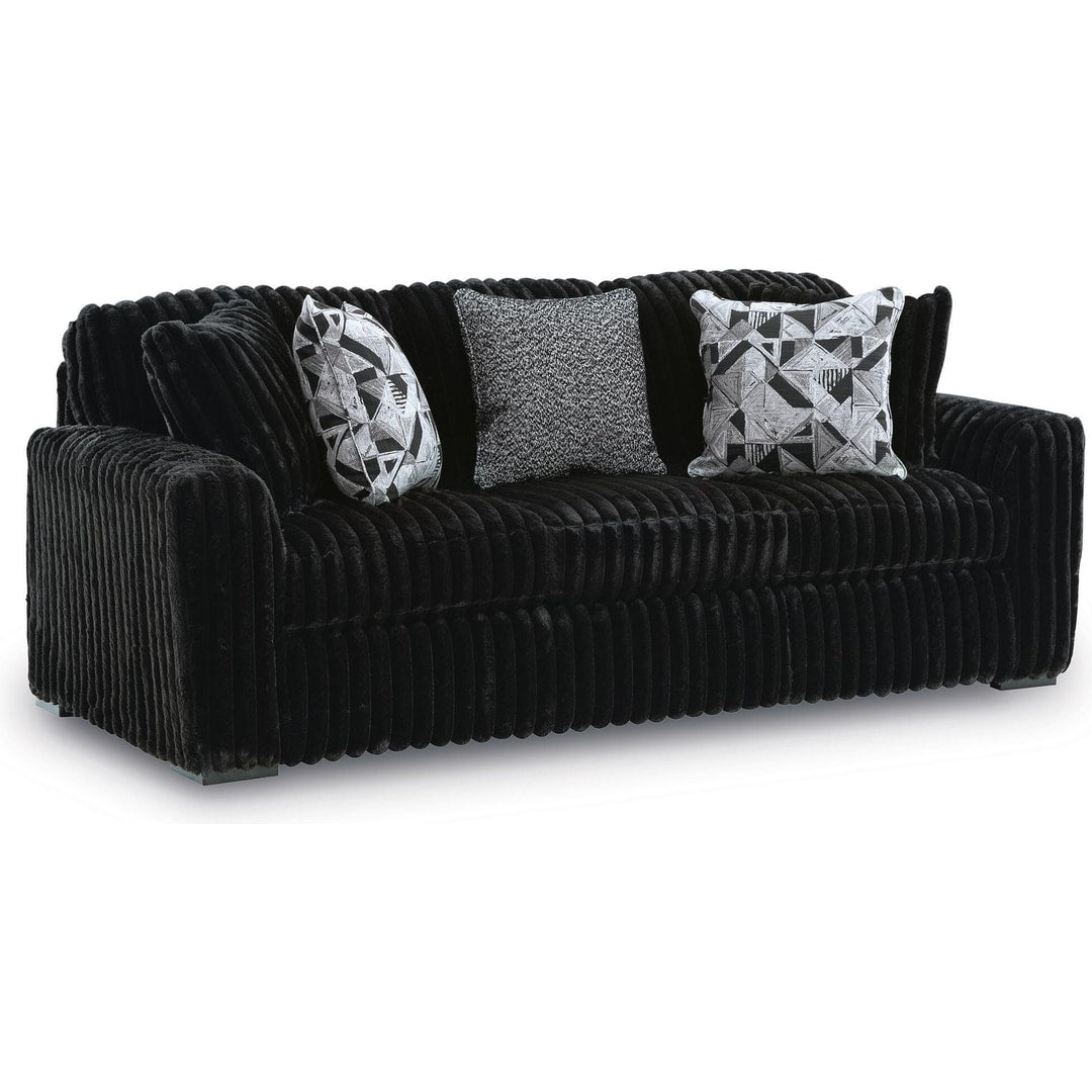 Midnight Madness sofa in Onyx jumbo corduroy with accent pillows, three-quarter front view on a white background