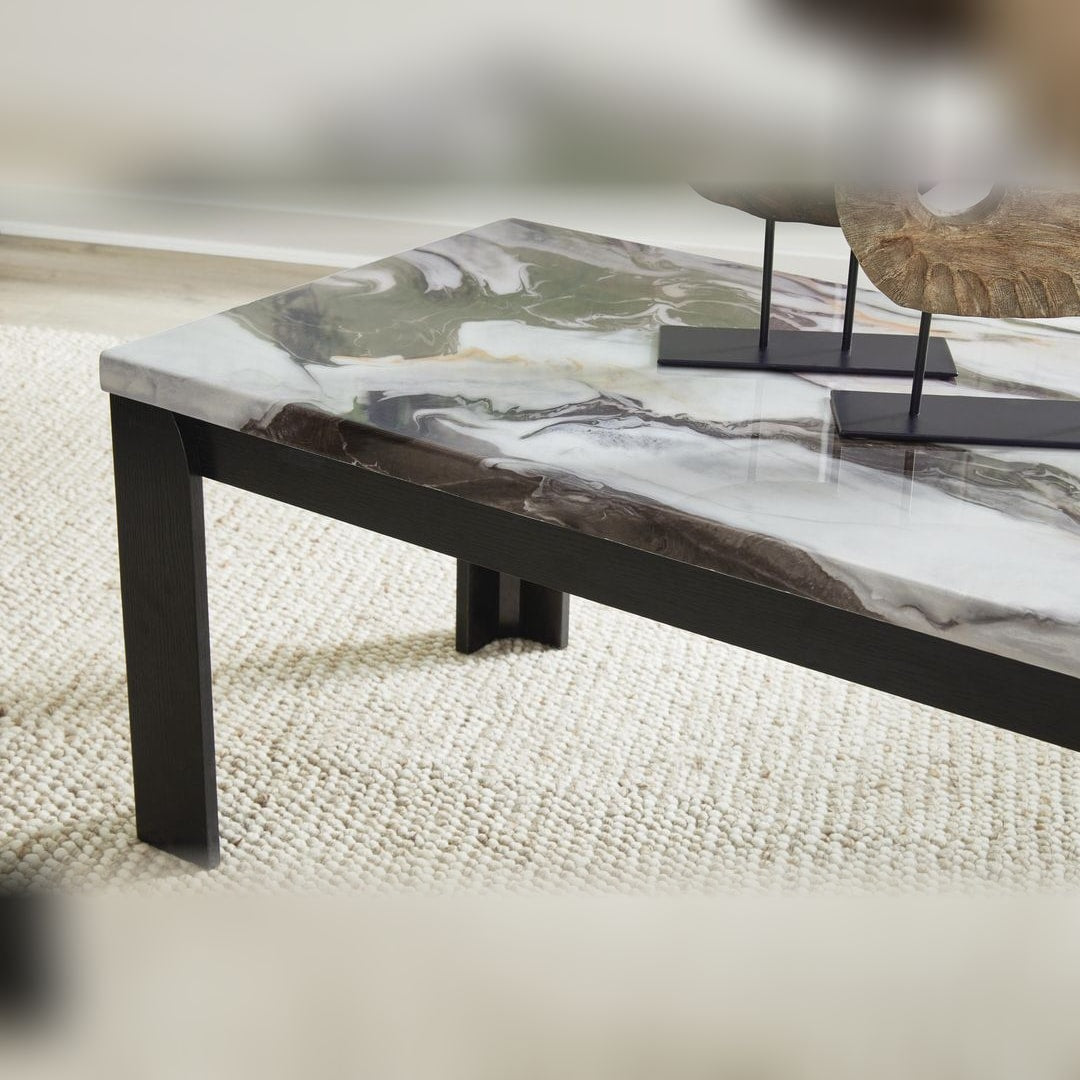 Close-up of the Jazmore cocktail table corner, showing the brown and white marble-pattern top over a dark leg