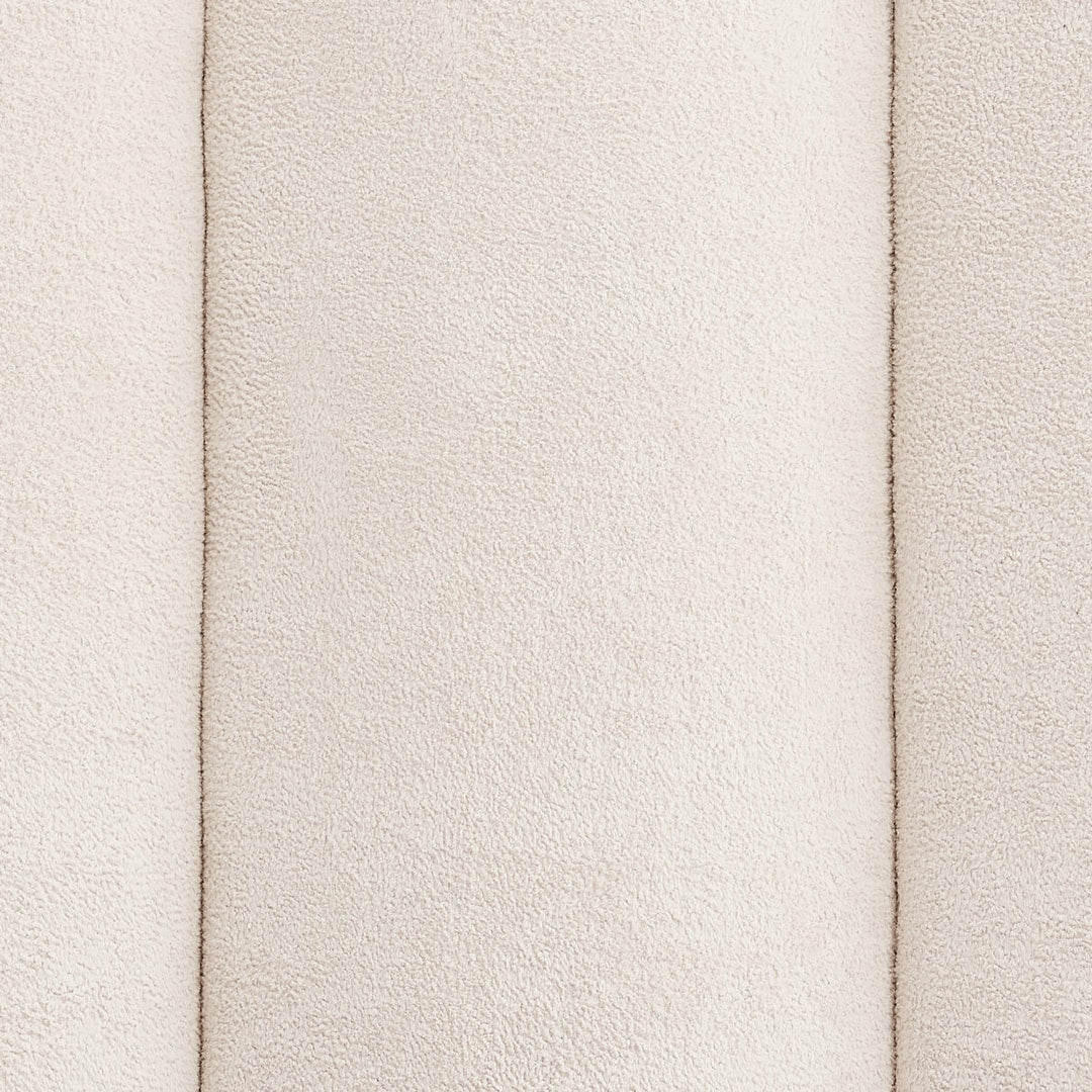 Close-up of the Serenity bed's soft cream upholstery and deep vertical fluting