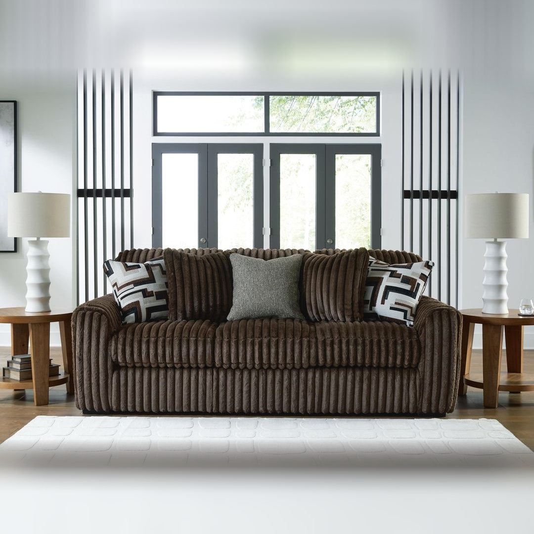 Midnight Madness Chocolate corduroy sofa styled between two lamp tables in a bright contemporary living room