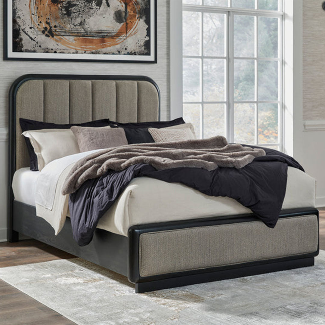 Modern upholstered bed frame with tufted headboard, neutral bedding, and abstract wall art in cozy bedroom