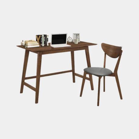 Modern wooden desk with matching chair, laptop, books, and decor for home office setup