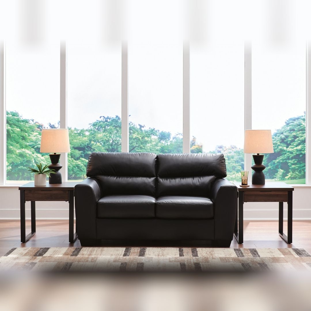 Gavello Midnight faux leather loveseat styled in a bright living room with a striped rug and window wall