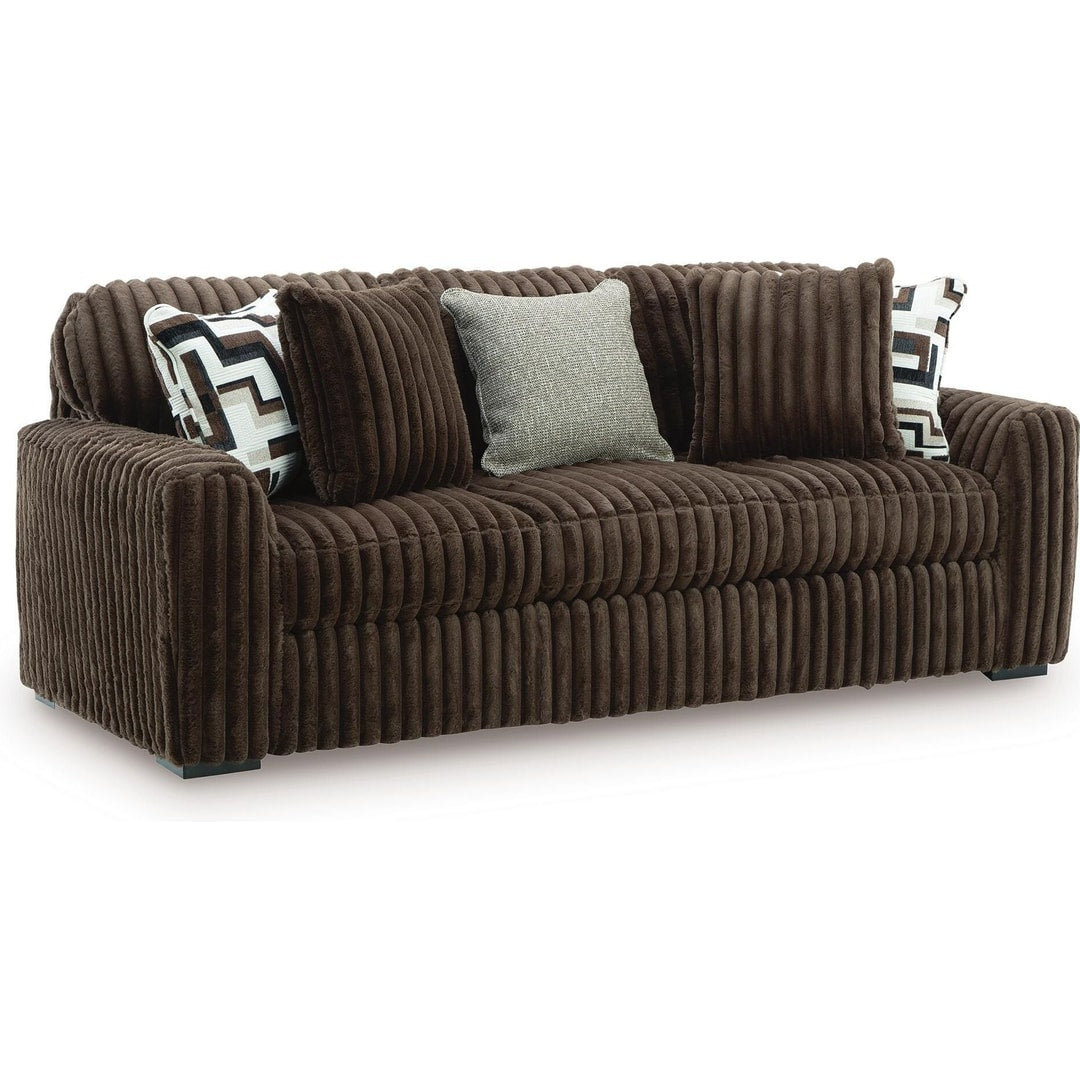 Midnight Madness sofa in Chocolate jumbo corduroy with accent pillows, three-quarter front view on a white background