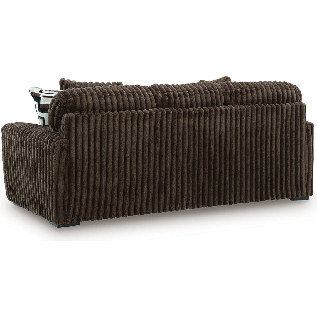 Rear three-quarter view of the midnight madness sofa, showing the finished back and low-profile legs