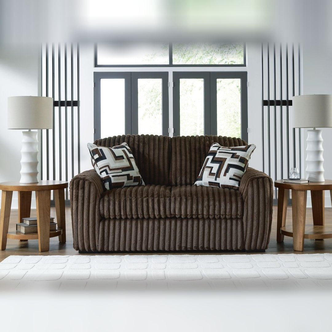 Midnight Madness Chocolate corduroy loveseat styled between two lamp tables in a bright contemporary living room