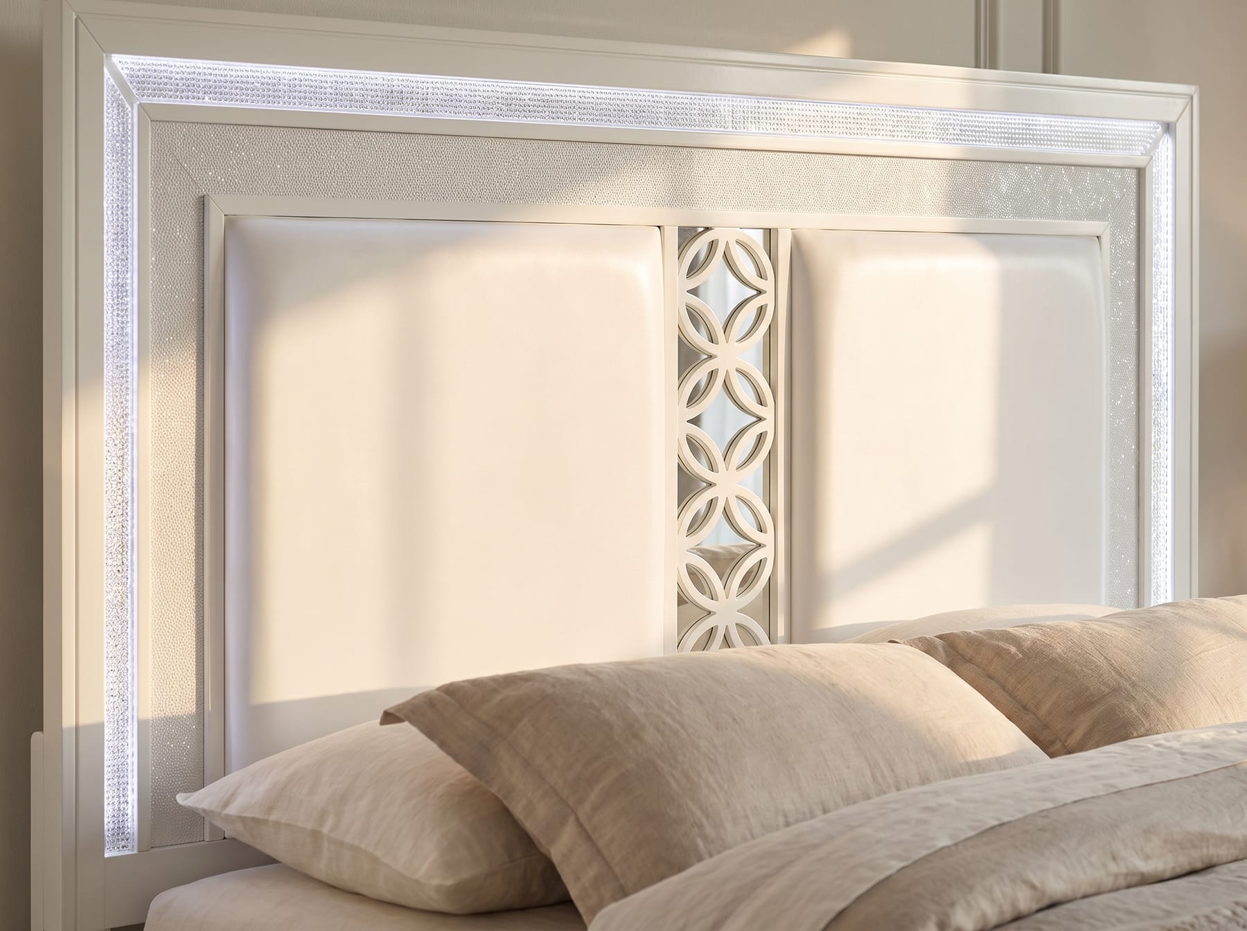 Close detail of the Abigale headboard showing the mirrored circular-lattice inset and crystal inlay trim