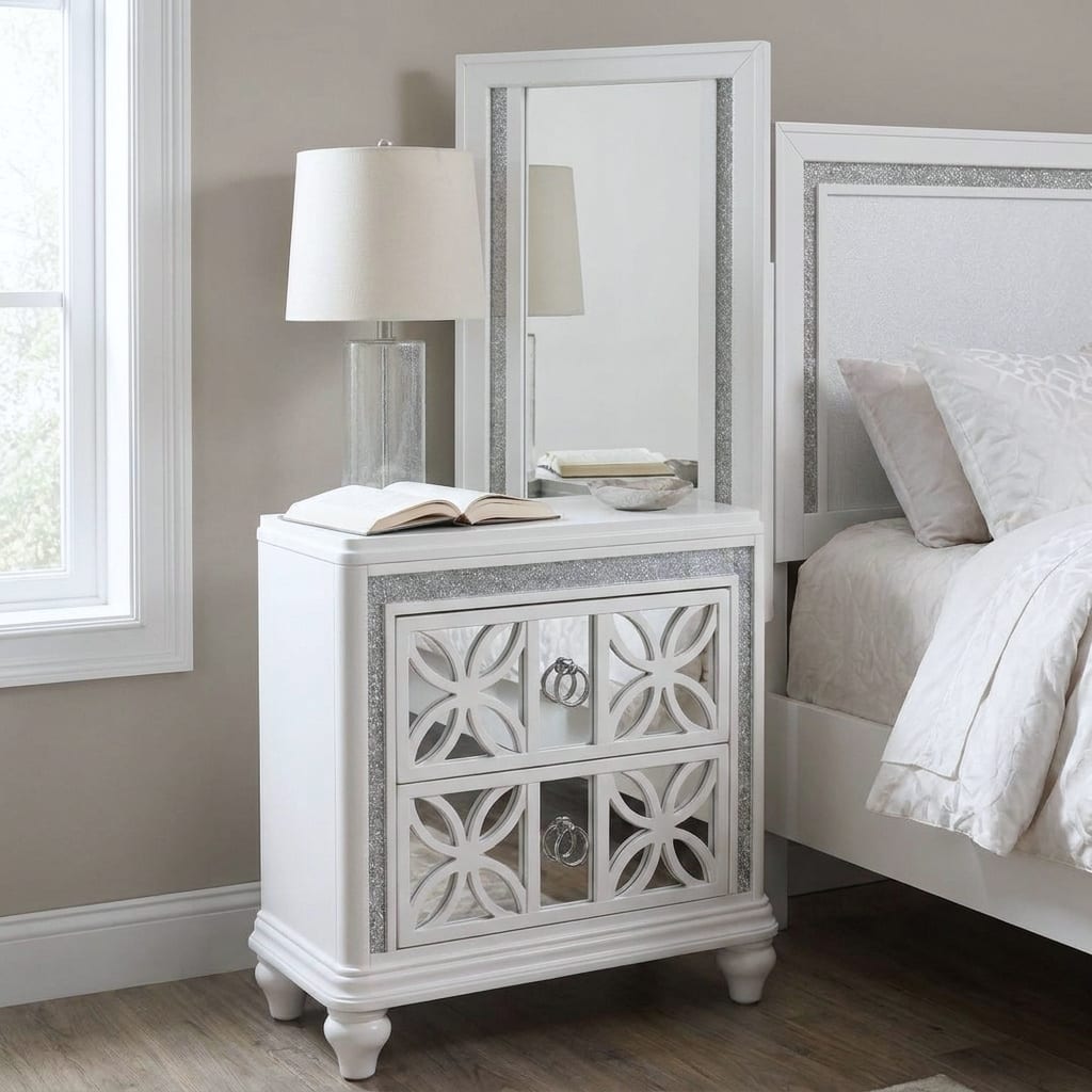 Abigale white nightstand with its mirror-top framed mirror, circular-lattice drawer fronts over mirrored panels and chrome ring pulls, in daylight beside the matching bed