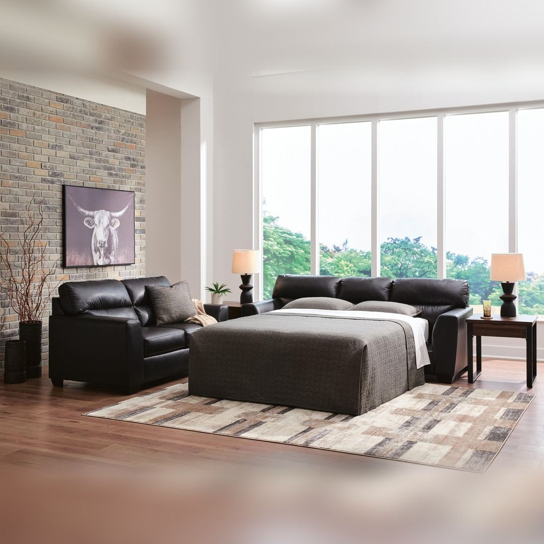Gavello queen sofa sleeper opened into a bed in a loft living room with a brick wall and window wall