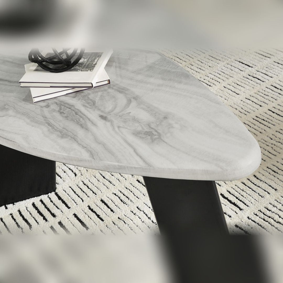 Close-up of the Lilyberg cocktail table's rounded corner and white-grey faux marble top