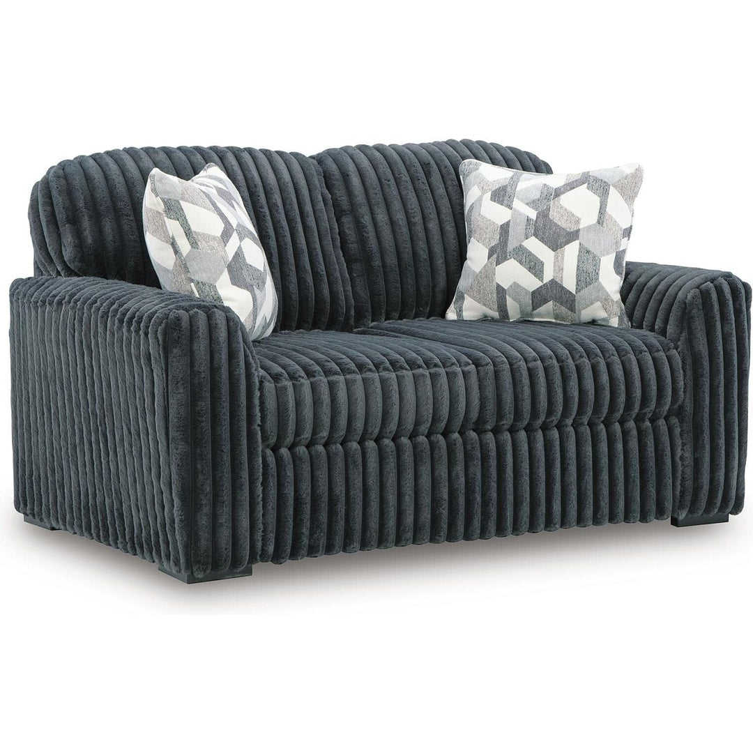 Midnight Madness loveseat in Gunmetal jumbo corduroy with accent pillows, three-quarter front view on a white background