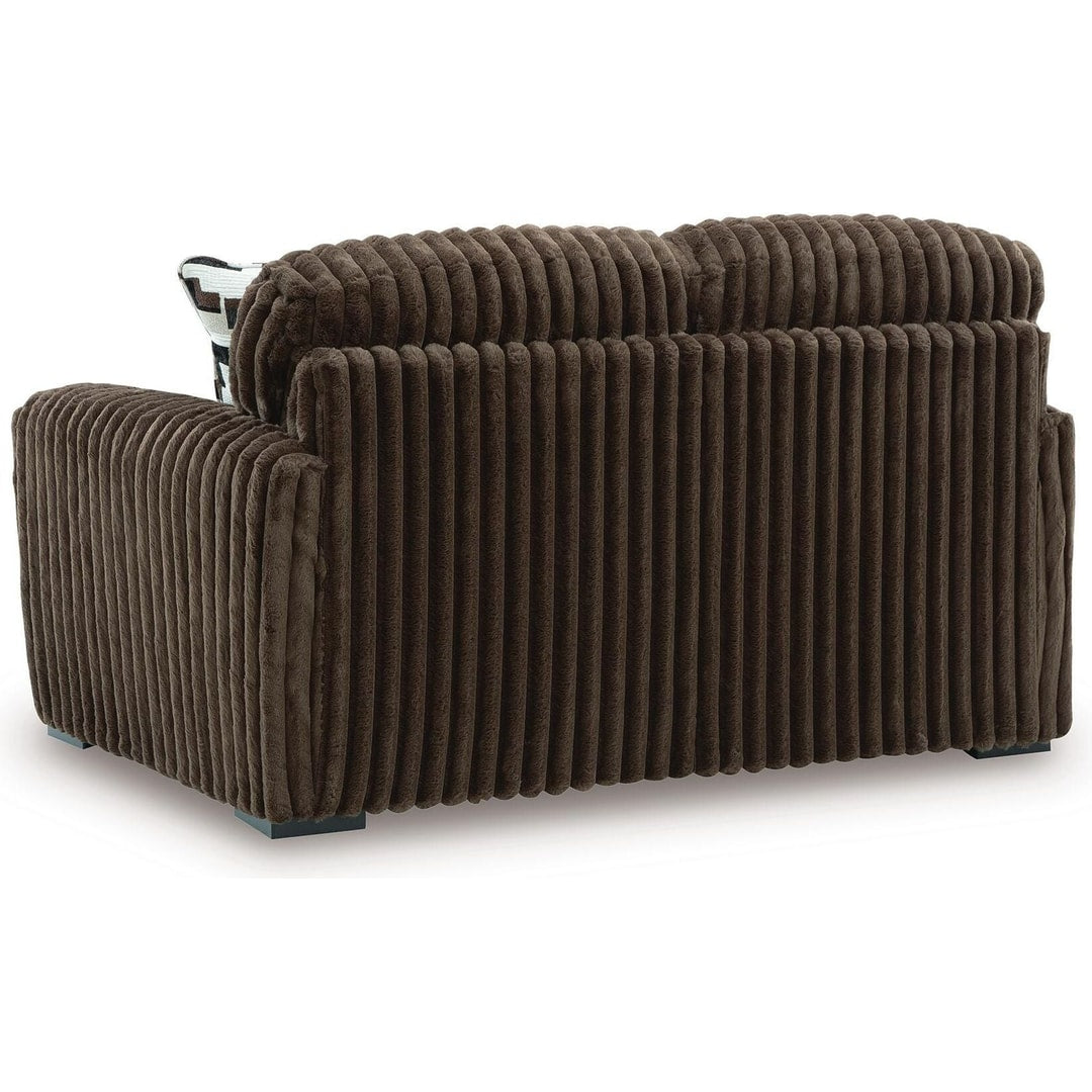 Rear three-quarter view of the midnight madness loveseat, showing the finished back and low-profile legs