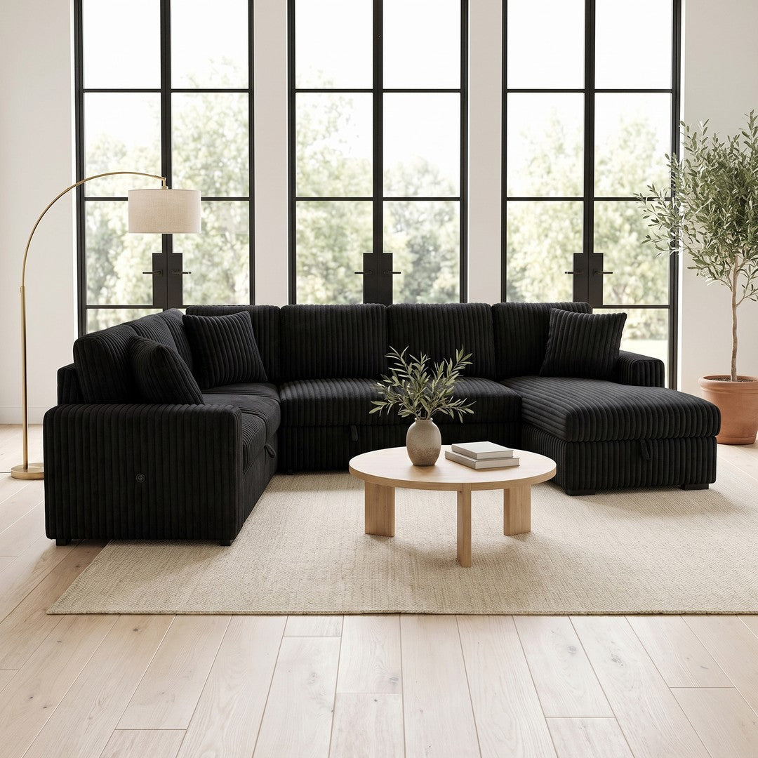 A black channel-tufted U-shaped sectional with a chaise in a bright living room